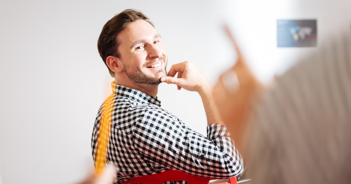 a man smiling touching his chin