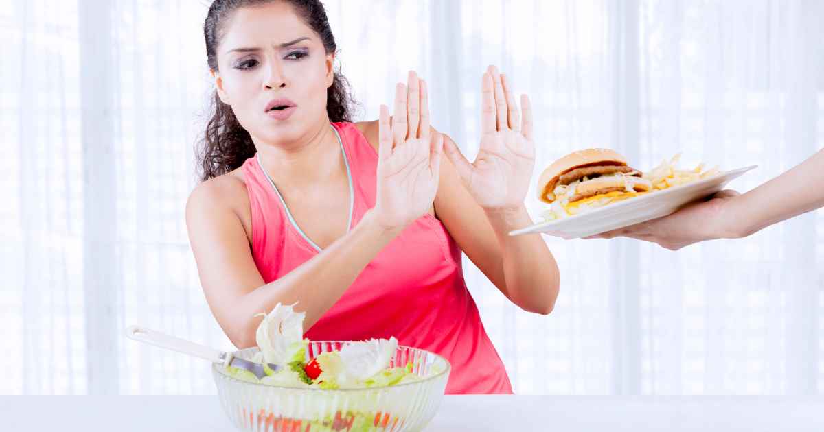 a woman saying NO to fast food or unhealthy foods