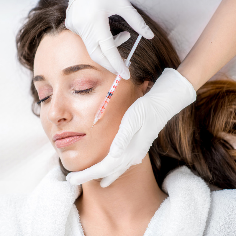 someone getting botox for their smile lines