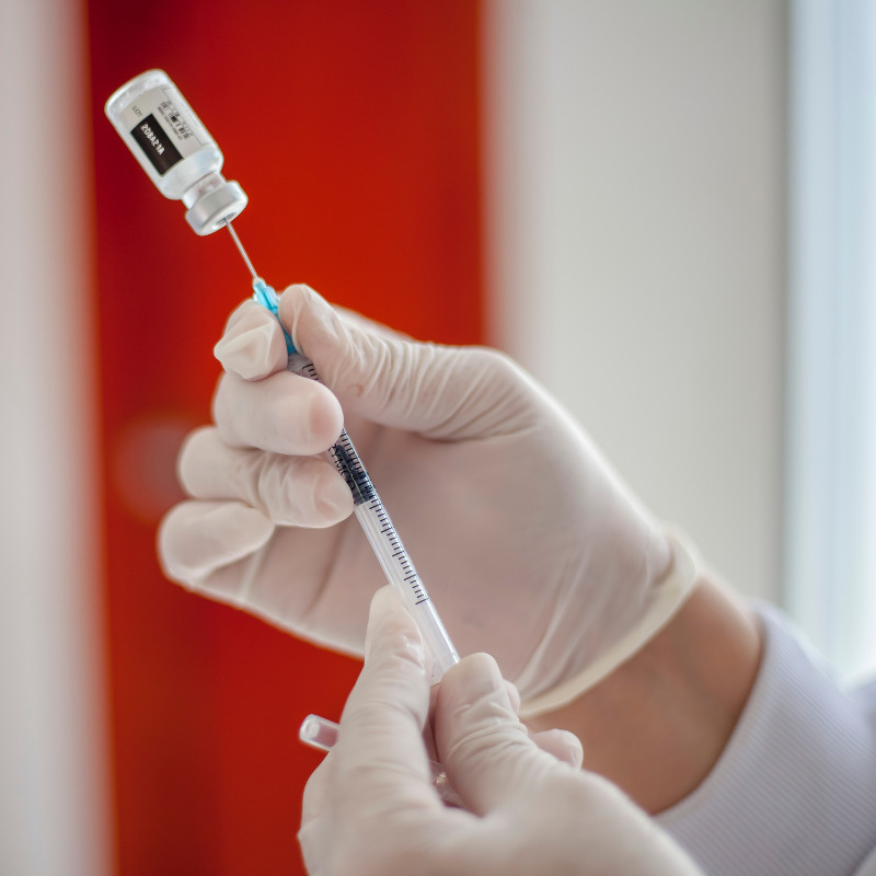 someone holding a vial of filler