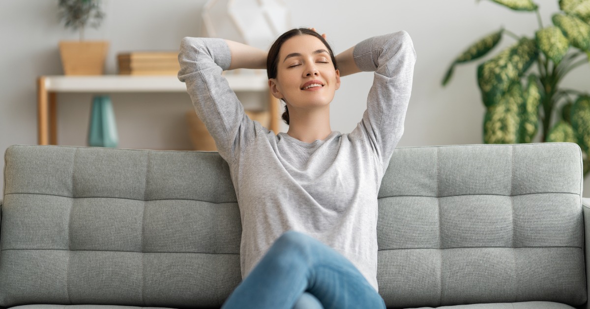 A woman resting at a couch.
