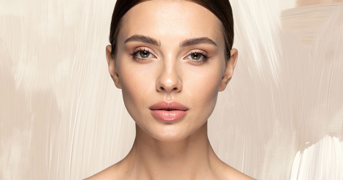 Close-up portrait of a woman with clear, glowing skin.