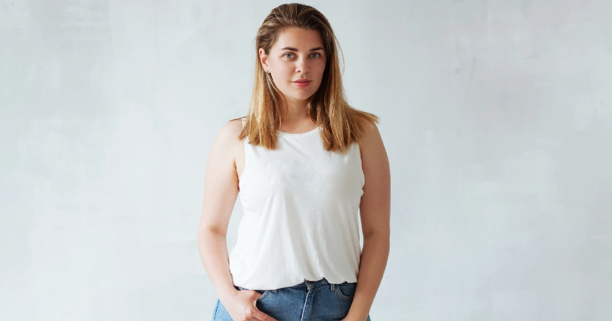 Confident woman in casual attire representing a healthy weight-loss journey.